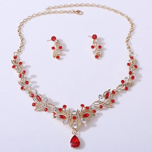 Detail of gold bridal jewelry set with red marquise crystals and waterdrop pendant