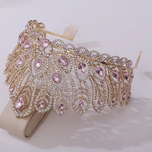 Detail of pink crystal teardrop tiara with golden feather design and hair comb base
