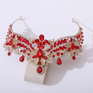 Macro shot of red crystal wedding crown with gold floral details and water drop pendants