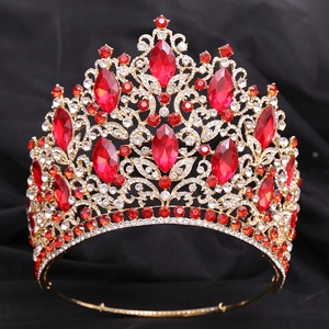 Detailed close-up of luxury Baroque golden crown with ruby red and clear crystals