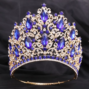 Detail of luxury gold tiara with royal blue crystals and sparkling leaf design