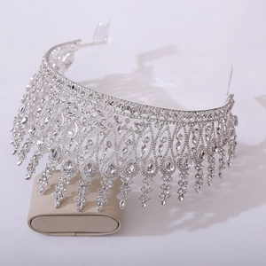 Detailed macro of silver baroque tiara featuring intricate rhinestones and pear-cut droplets