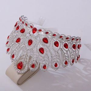 Macro detail of red teardrop gemstones and white crystals on a silver pageant crown