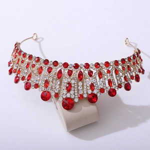 Detailed close-up of a baroque crown with red crystals and gold-plated alloy base
