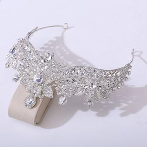 Detailed macro view of bridal alloy crown with floral rhinestones and crystal leaf accents