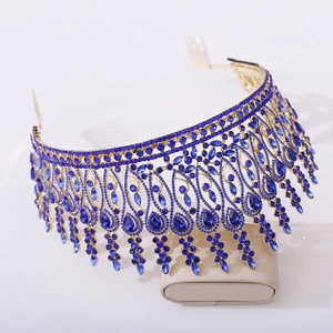 Detail of baroque gold tiara with deep blue rhinestones and side combs for pageant