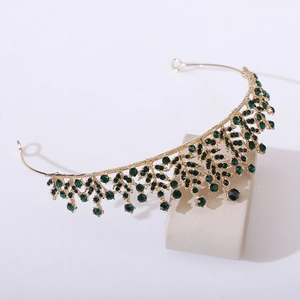 Detailed close-up of Baroque gold bridal crown with emerald crystals and branched leaf design