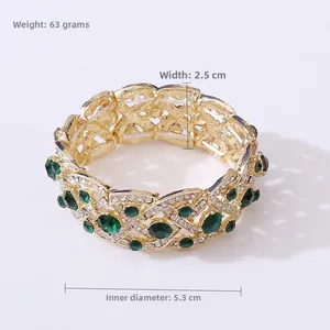 Detailed view of vintage gold-tone elastic bridal bracelet with emerald stones and crystals