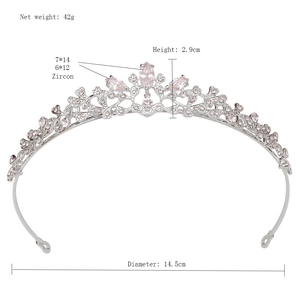 Detail view of bridal crown tiara showing silver alloy with zircon leaves and pink stones