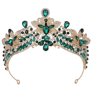 Detailed view of the gold alloy bridal tiara with green gems and white rhinestones