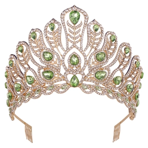 Detail of pageant crown with emerald green teardrop stones and gold peacock feather base