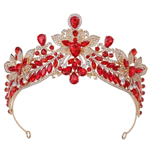 Detailed close-up of golden bridal crown featuring red crystal petals and sparkling white rhinestones
