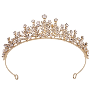 Close-up of golden bridal tiara featuring shimmering crystals and floral leaf details