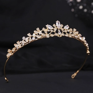 Close-up of golden bridal crown featuring leaf vine patterns and marquise cut crystals