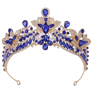 Exquisite gold bridal crown with blue crystals and white rhinestones on white background
