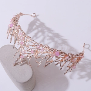 Close-up of rose gold bridal crown featuring pink pearls and crystal branch details