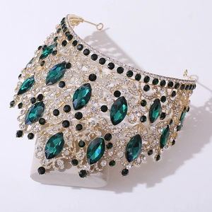 Luxurious gold crystal bridal crown with emerald green stones and diamond accents