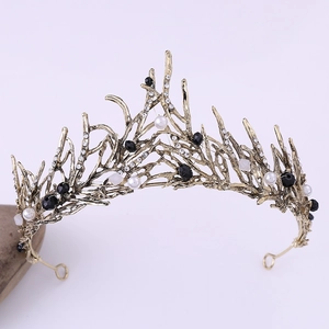 Macro detail of bridal tiara with gold branches, white pearls and black crystal beads