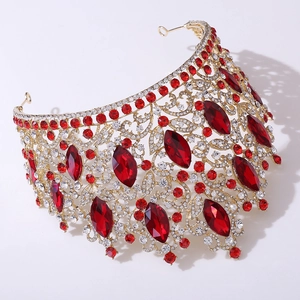 Close-up of luxury bridal tiara with golden leaf patterns and red marquise crystals