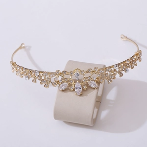 Elegant gold bridal crown with leaf patterns and zircon crystals for wedding hair