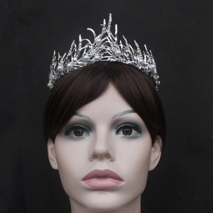 Elegant silver twig bridal tiara with white pearls on a model against a black background