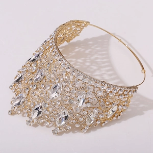 Close-up of golden leaf crown featuring intricate hollow metalwork and sparkling rhinestones