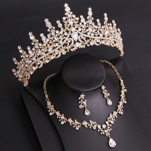 Close-up of golden bridal jewelry set with sparkling rhinestones and teardrop pendants