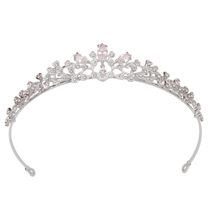 Detailed close-up of bridal tiara with pink zircon stones and silver leaf filigree