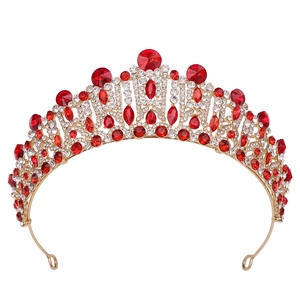 Macro shot of gold wedding crown detailing red gemstones and white crystals