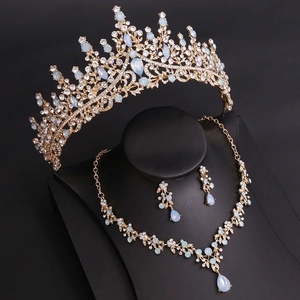 Detail of bridal gold tiara necklace and earrings set with light blue crystals