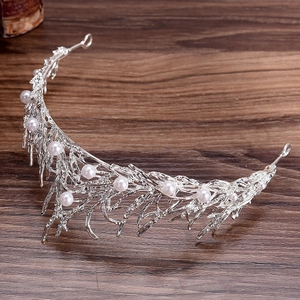 Detailed close-up of bridal headband featuring silver leaves with pearls and rhinestones