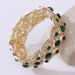 Elegant gold hollow bracelet with green synthetic gems and white crystals for brides