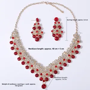Detail of luxury bridal jewelry set with red gemstones and sparkling white rhinestones