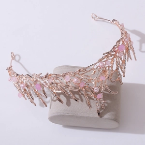 Detailed macro of rose gold bridal crown with pink pearls and branches