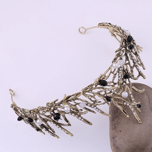 Macro detail of bridal tiara with pearls and crystals on bronze branch frame