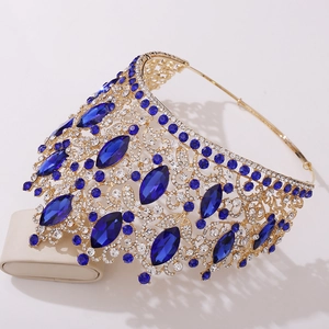 Detail view of a luxury gold bridal tiara featuring navy blue gems and white rhinestones
