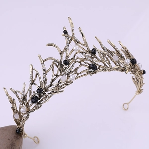 Macro detail of vintage gold bridal crown with white pearls and sparkling rhinestones