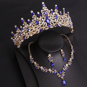 Detailed macro view of bridal jewelry set with blue gemstones and baroque gold crown
