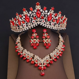 Detailed view of luxury bridal set with red crystal crown, necklace and drop earrings