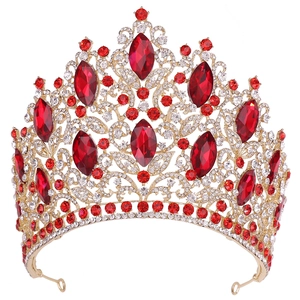 Macro view of luxury golden bridal crown with red marquise crystals and rhinestones