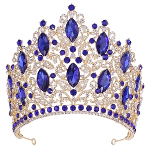 Close-up of luxury gold crown with blue marquise crystals and sparkling white rhinestones