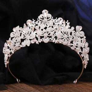 Detailed view of silver bridal crown featuring leaf designs and sparkling clear rhinestones