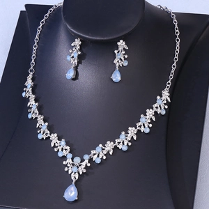 Detail of bridal jewelry set featuring blue teardrop crystal necklace and earrings