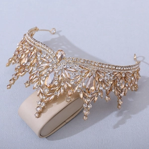 Detailed view of champagne crystal tiara with golden metallic base and drop pendants