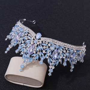 Close-up of light blue teardrop crystal crown with silver alloy and tassel details