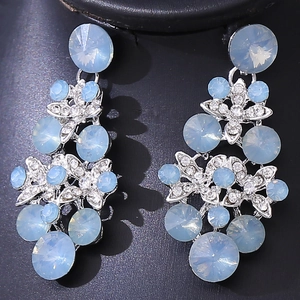 Close-up of luxury light blue floral butterfly dangle earrings with silver rhinestones