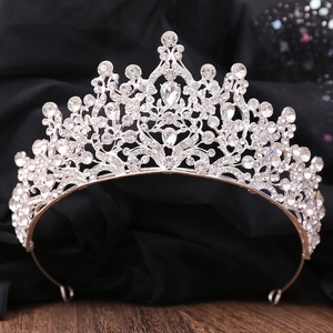 Detailed view of silver bridal crown with intricate baroque patterns and sparkling crystals