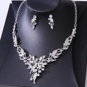 Detail of silver leaf bridal necklace and matching earrings with sparkling rhinestones