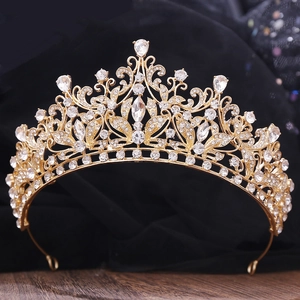 Close-up of golden Baroque crown with sparkling rhinestones and intricate leaf design