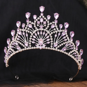 Detailed macro view of intricate silver alloy crown with purple rhinestones and crystals